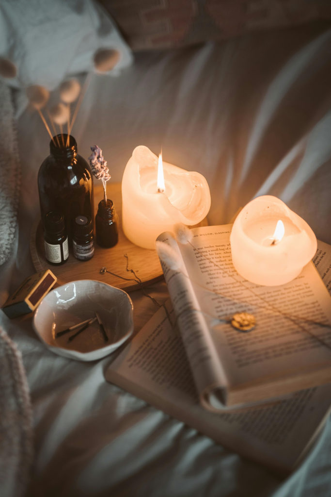 Candles and a book on a bed