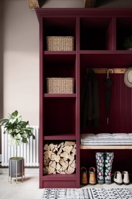 Boot room with red built-in shelving and white walls