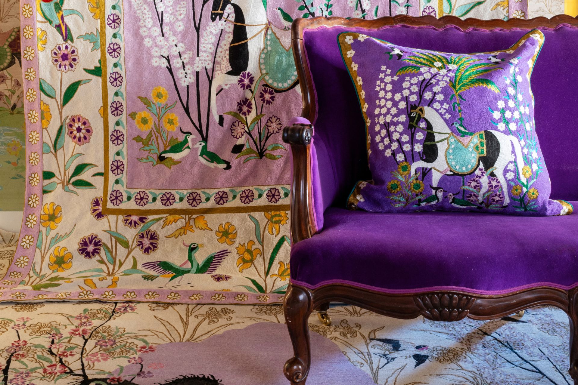 Deep purle velvet chair with matching lilac cushion and yellow and lilac wall hanging