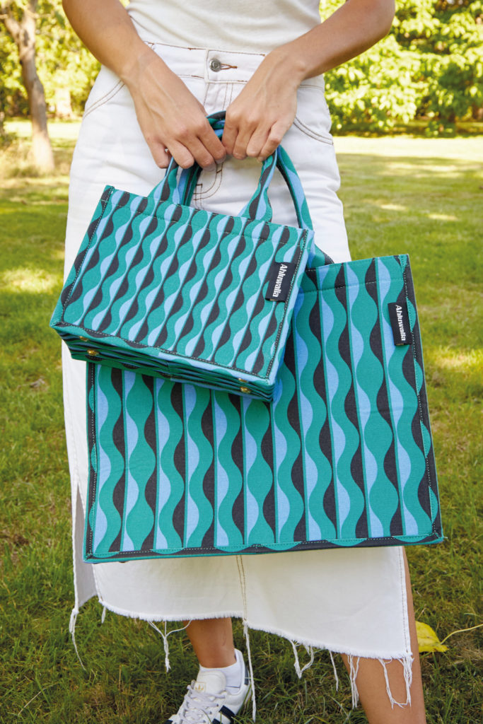 Woman holding blue bags