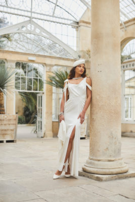 Woman lounging against column