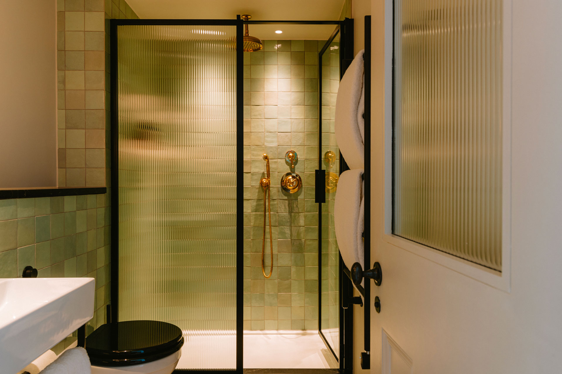 The bathroom - a green-tiled shower