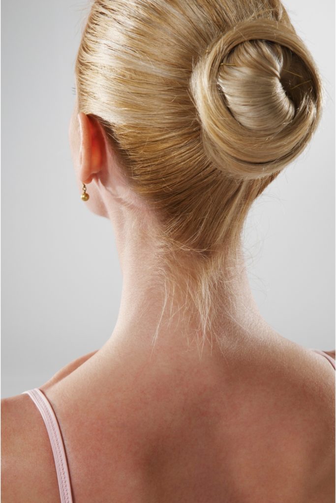 Woman with blonde slick back bun | hair damage