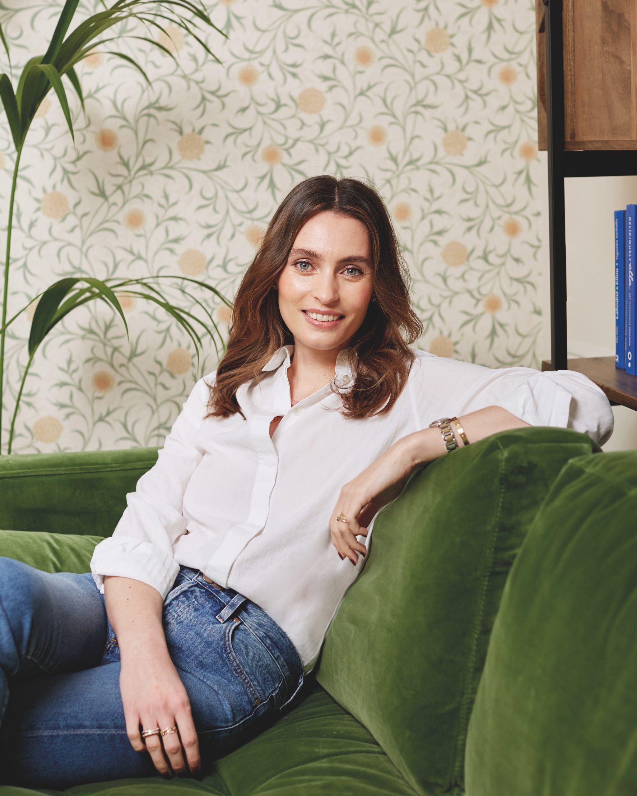 Ella Mills on a green sofa