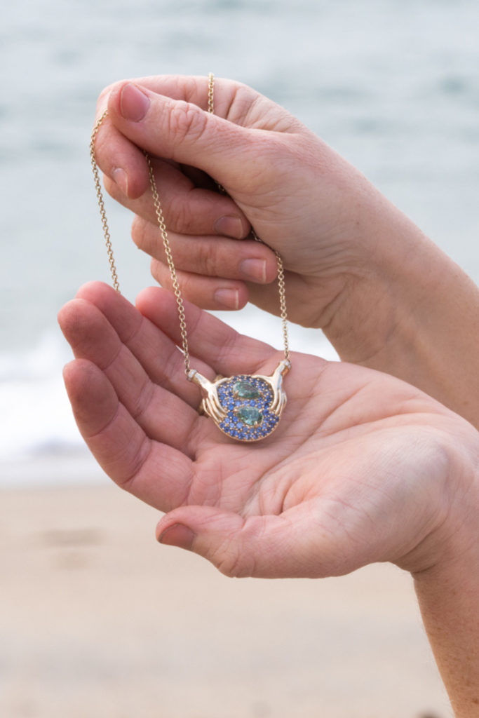 Hands holding pendant