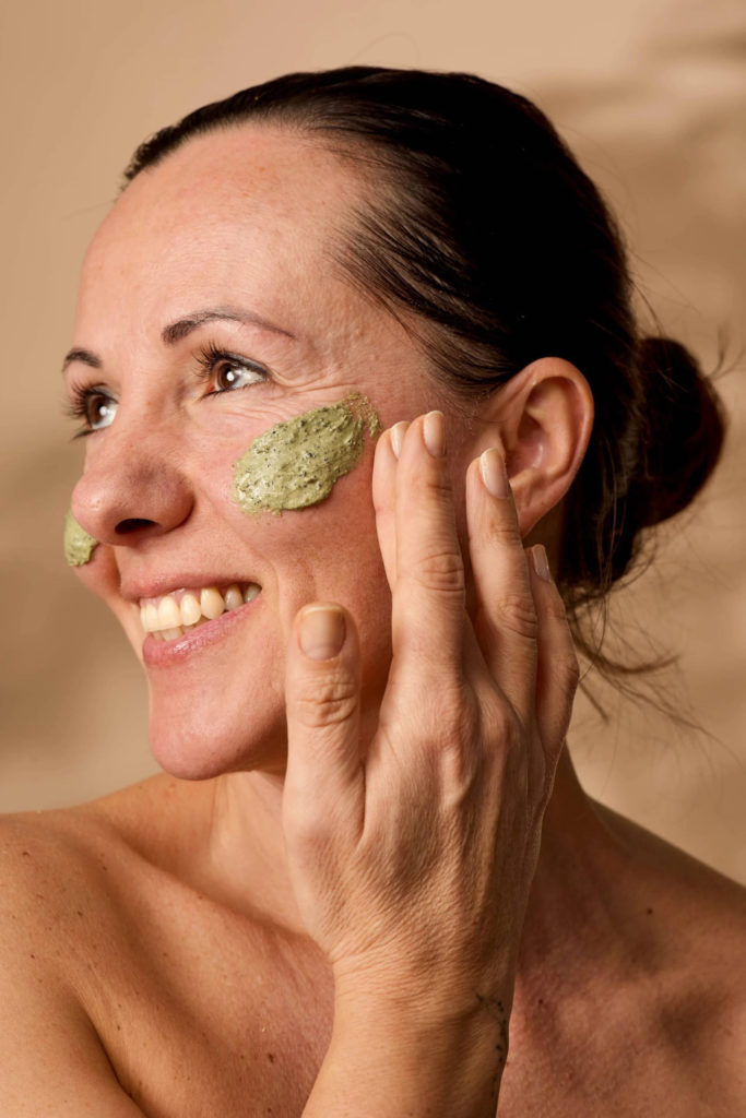 Woman with cream on her skin