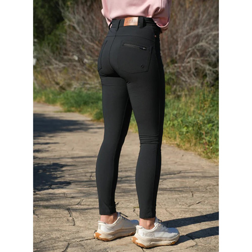 A woman wearing black skin-tight trousers