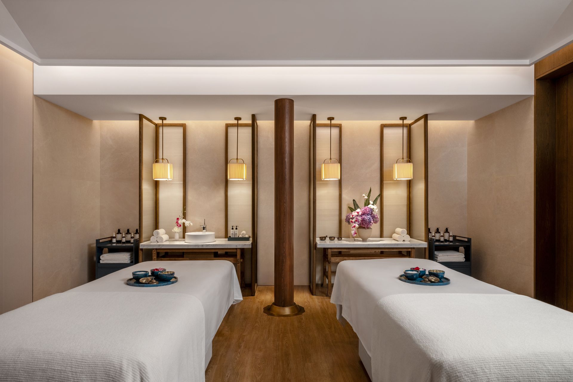 Chinese spa with white beds and wooden floors