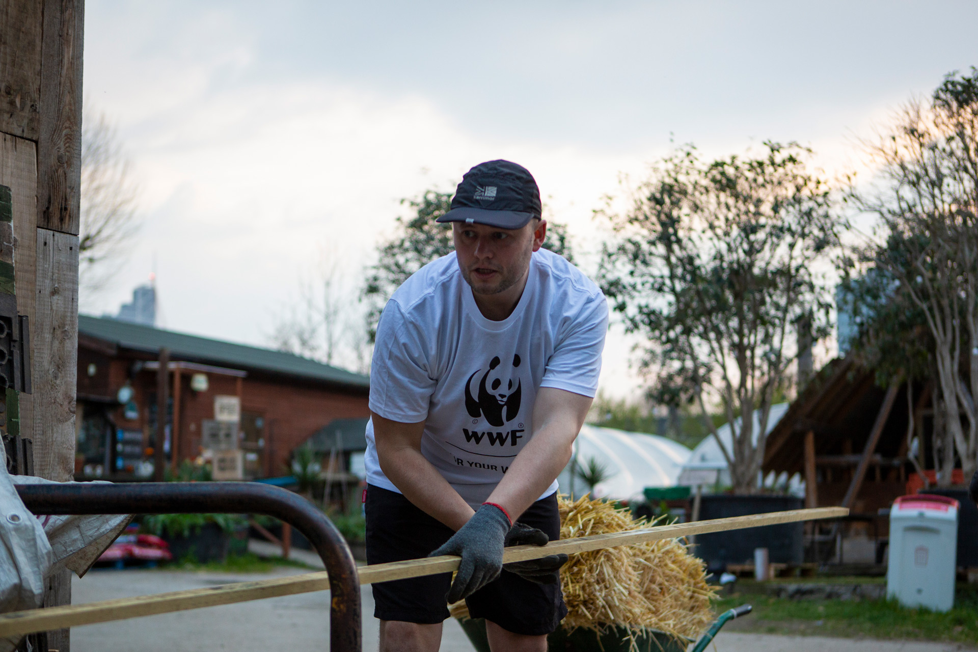 Runner moving wood as part of fundraiser at Spitalfields City Farm