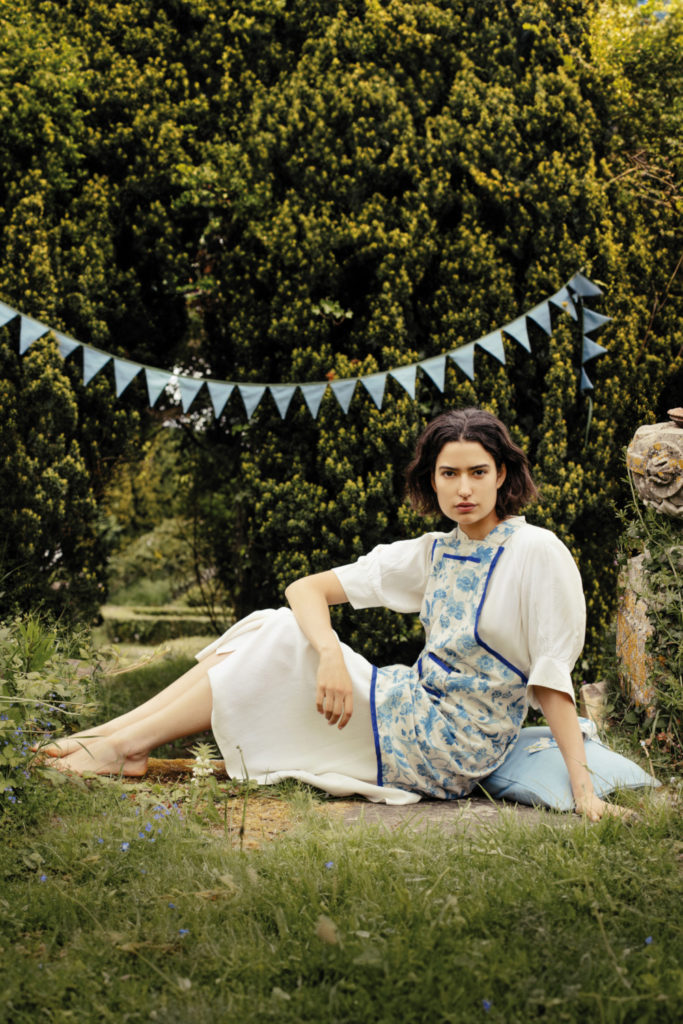 Woman sat in garden wearing Remnant Revolution clothing