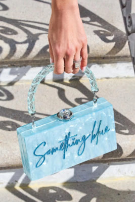 Hand holding blue bag