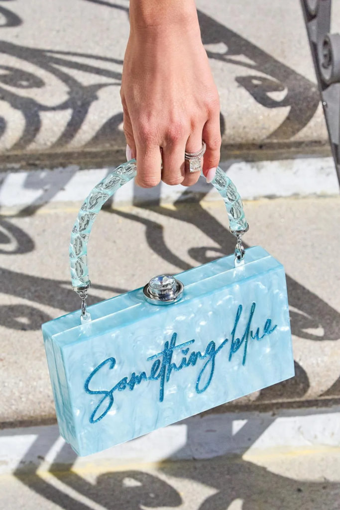 Hand holding blue bag