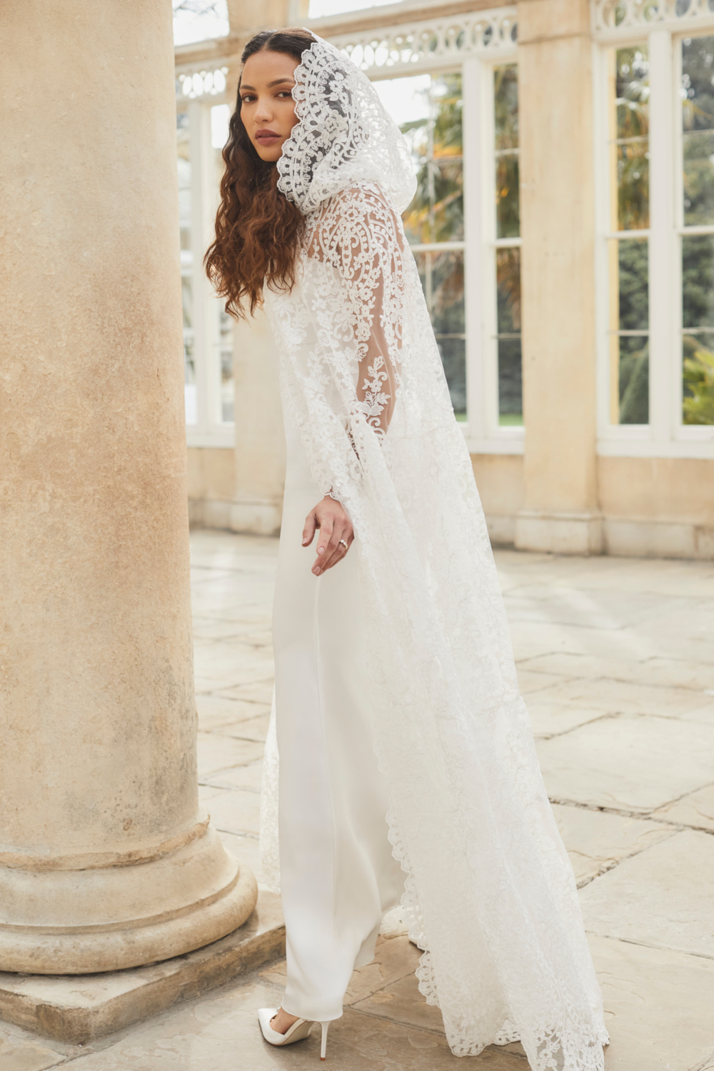 Woman in white dress and lace cape | Temperley London Bridal 2026