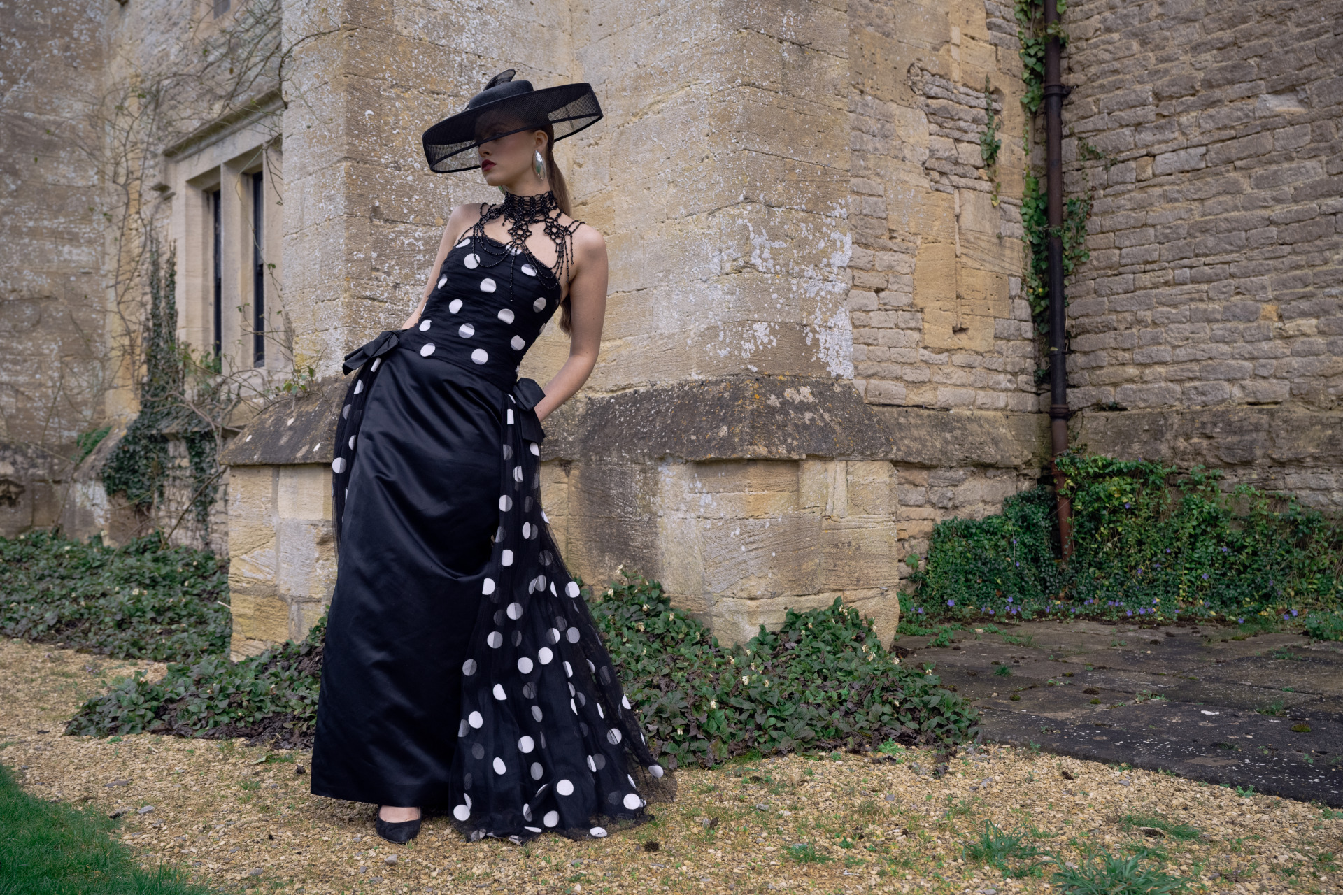 Woman in black dress and hat