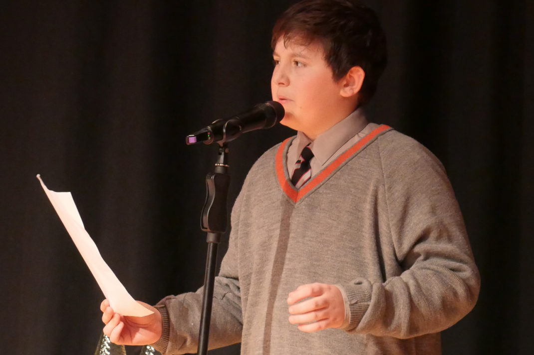 Westminster Under Student reading poetry on stage