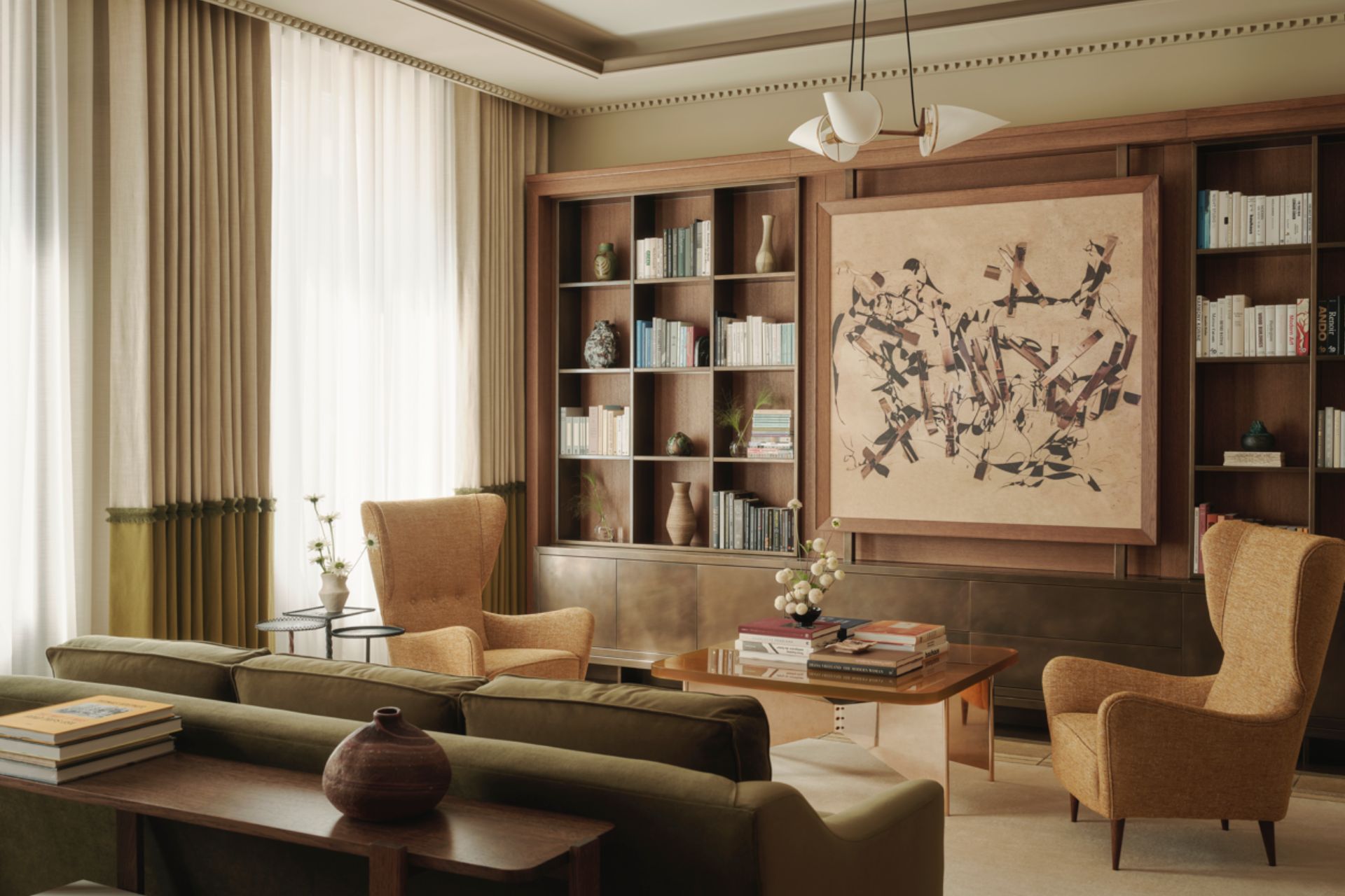 Living room with taupe walls, olive green sofas and built-in bookshelves