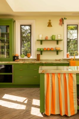 Colours of Arley avocado green kitchen with tangerine and white striped cafe curtain