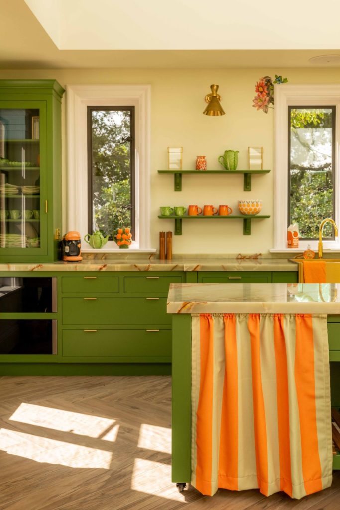 Colours of Arley avocado green kitchen with tangerine and white striped cafe curtain
