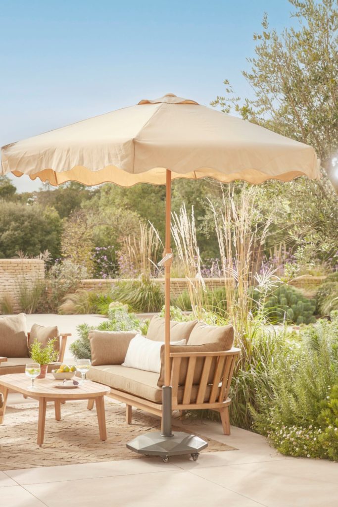 Garden with cream outdoor furniture and matching parasol