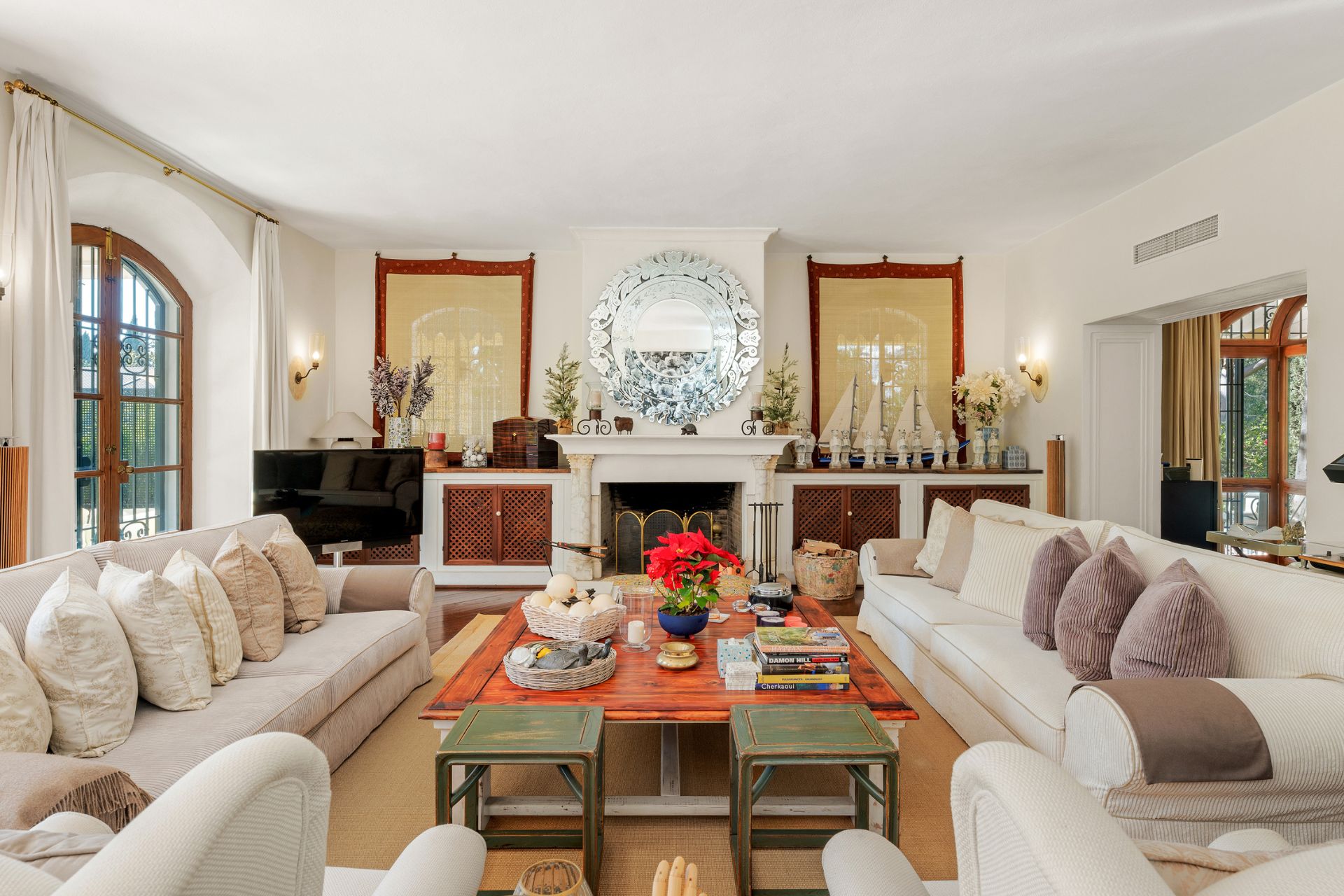 Living room with white sofas, wooden floors and a central coffee table