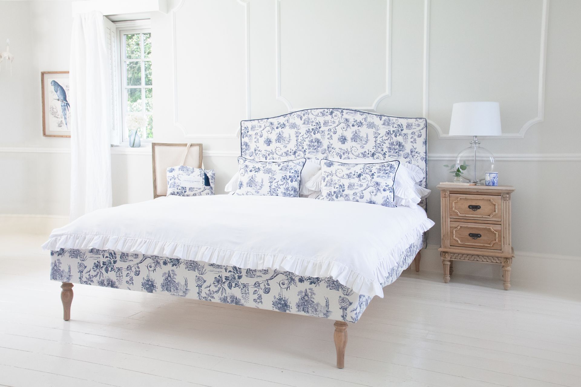 Blue and white toile bedframe with white bedding