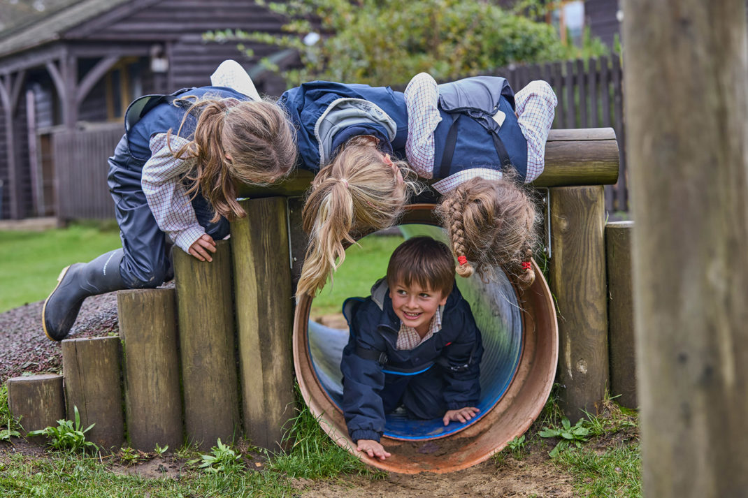 Highfield and Brookham young students in a playground tunnel