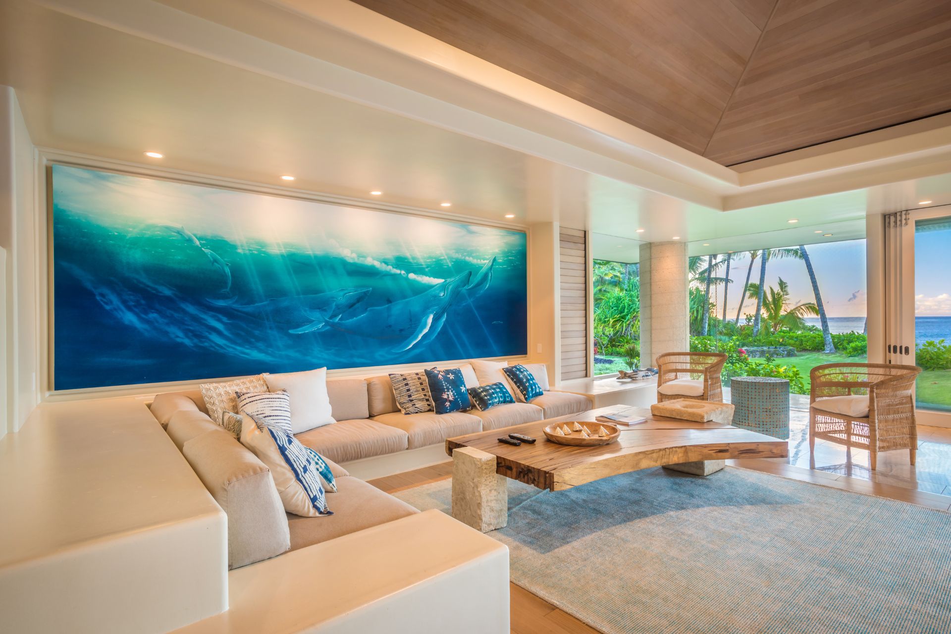 Hawaii mansion lounge with ocean artwork and white corner sofa