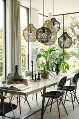 Conservatory dining area with rattan light pendants and floor-to-ceiling windows