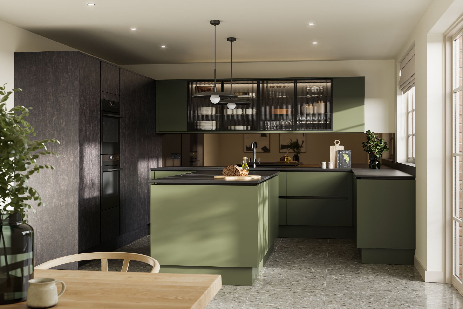 Deep olive green kitchen with black worktops and pale wooden dining table