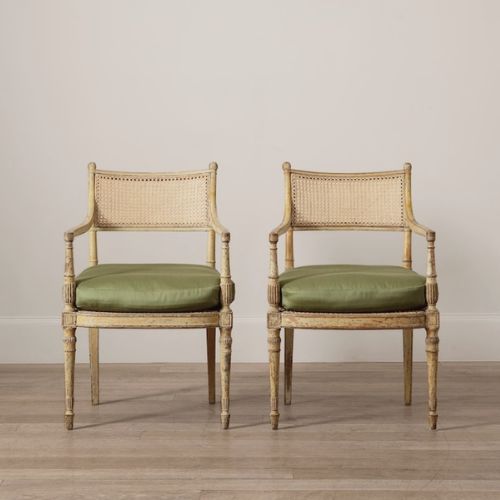 Cane panelled Regency armchairs with green seat cushions