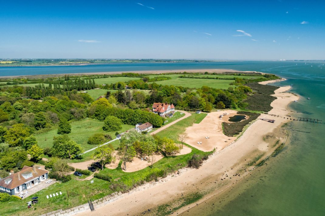 Aerial view of island with wooded areas and clusters of homes