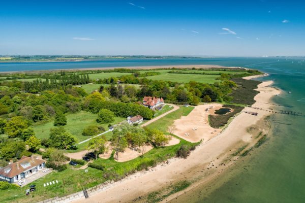 Aerial view of island with wooded areas and clusters of homes