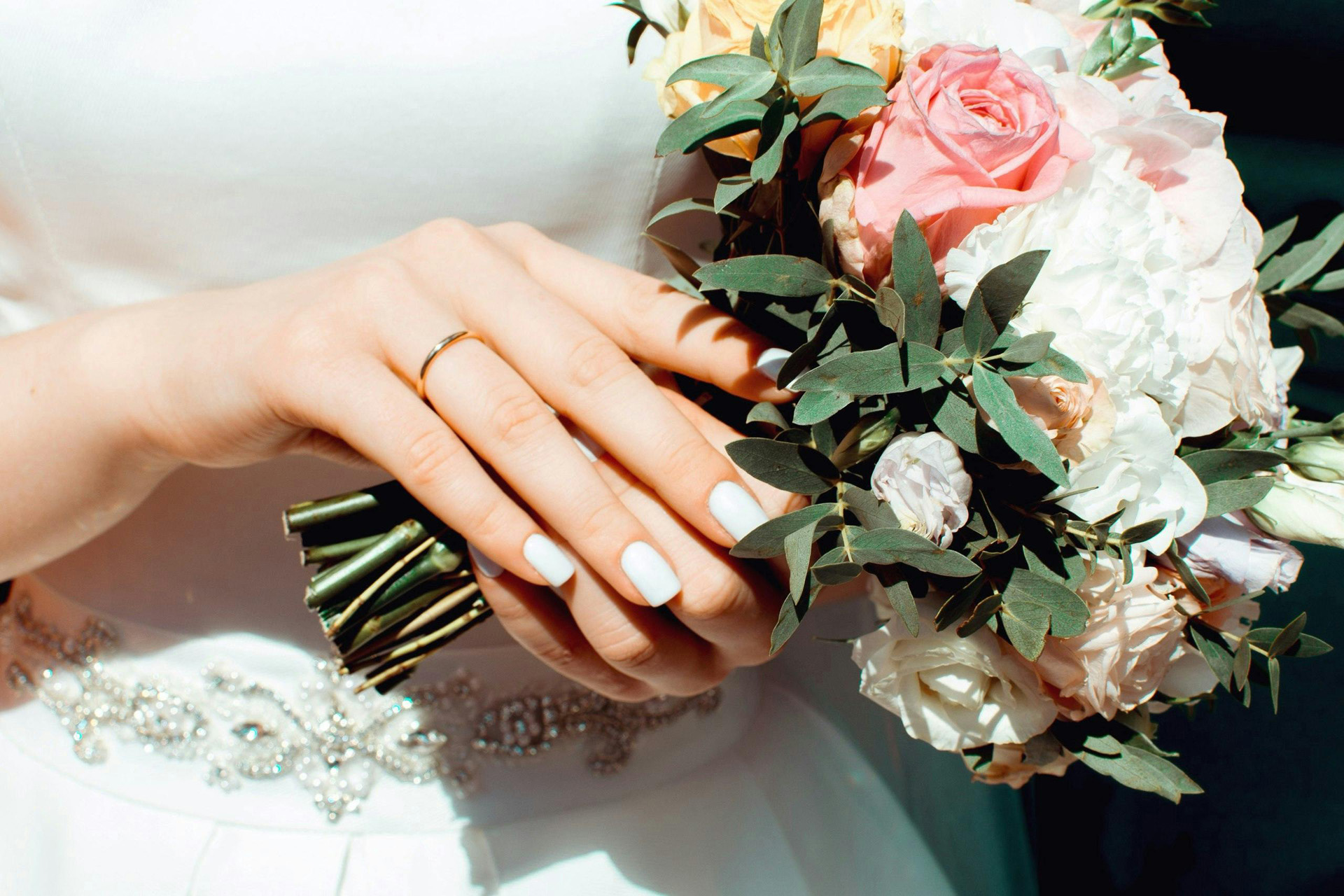 Hands holding a wedding bouquet