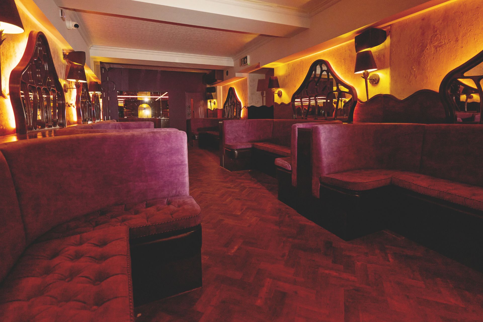 Club with deep red velvet seating and carpets