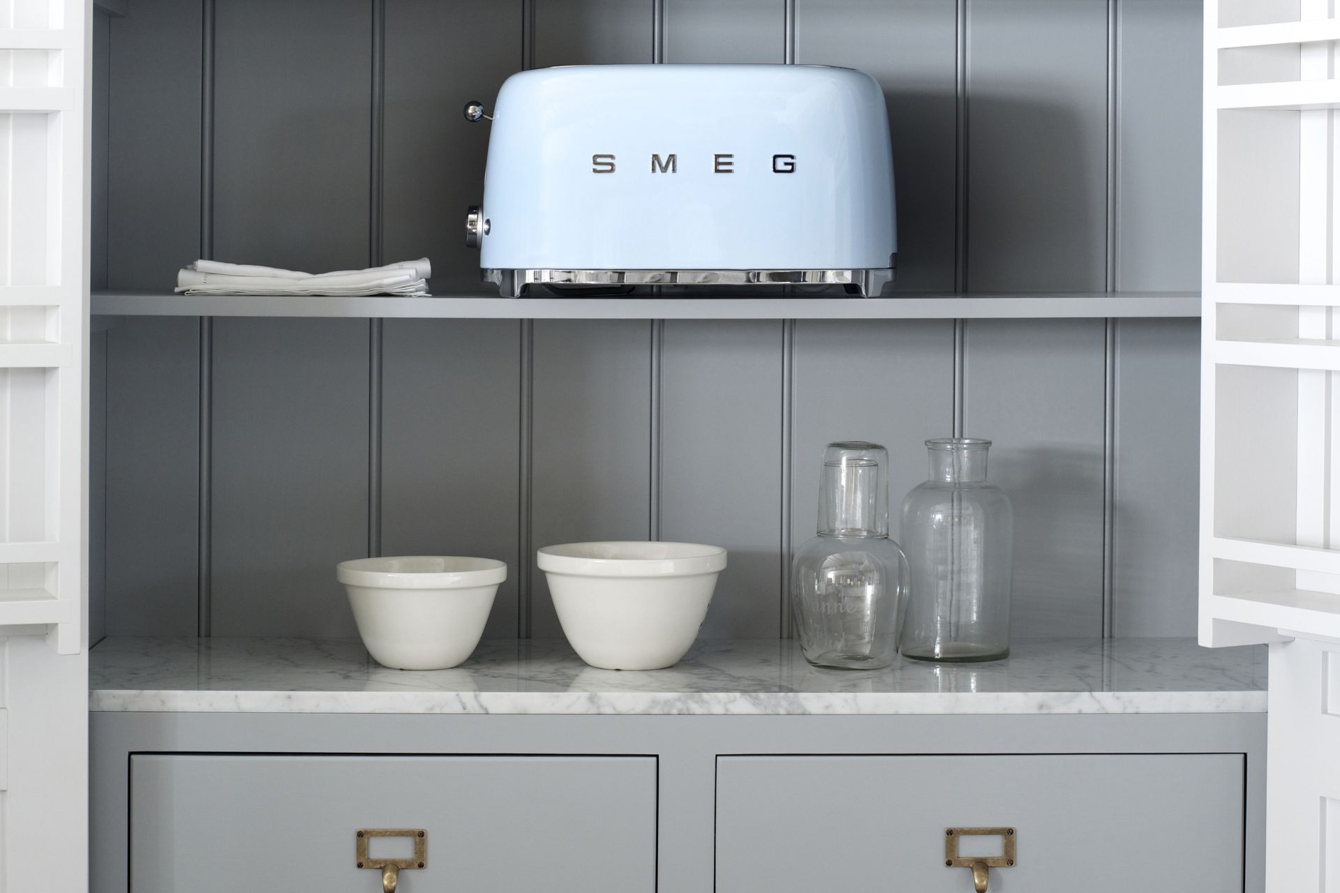 Pale grey kitchen with pale blue Smeg toaster