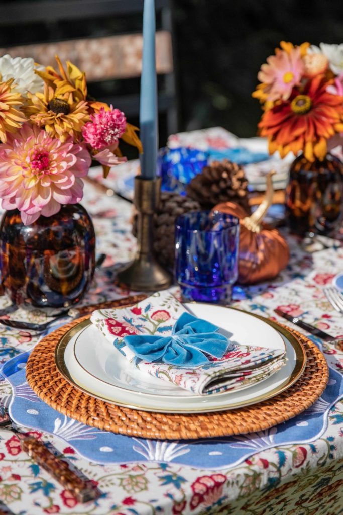 Blue floral tablescape with tortoiseshell vases full of dahlias