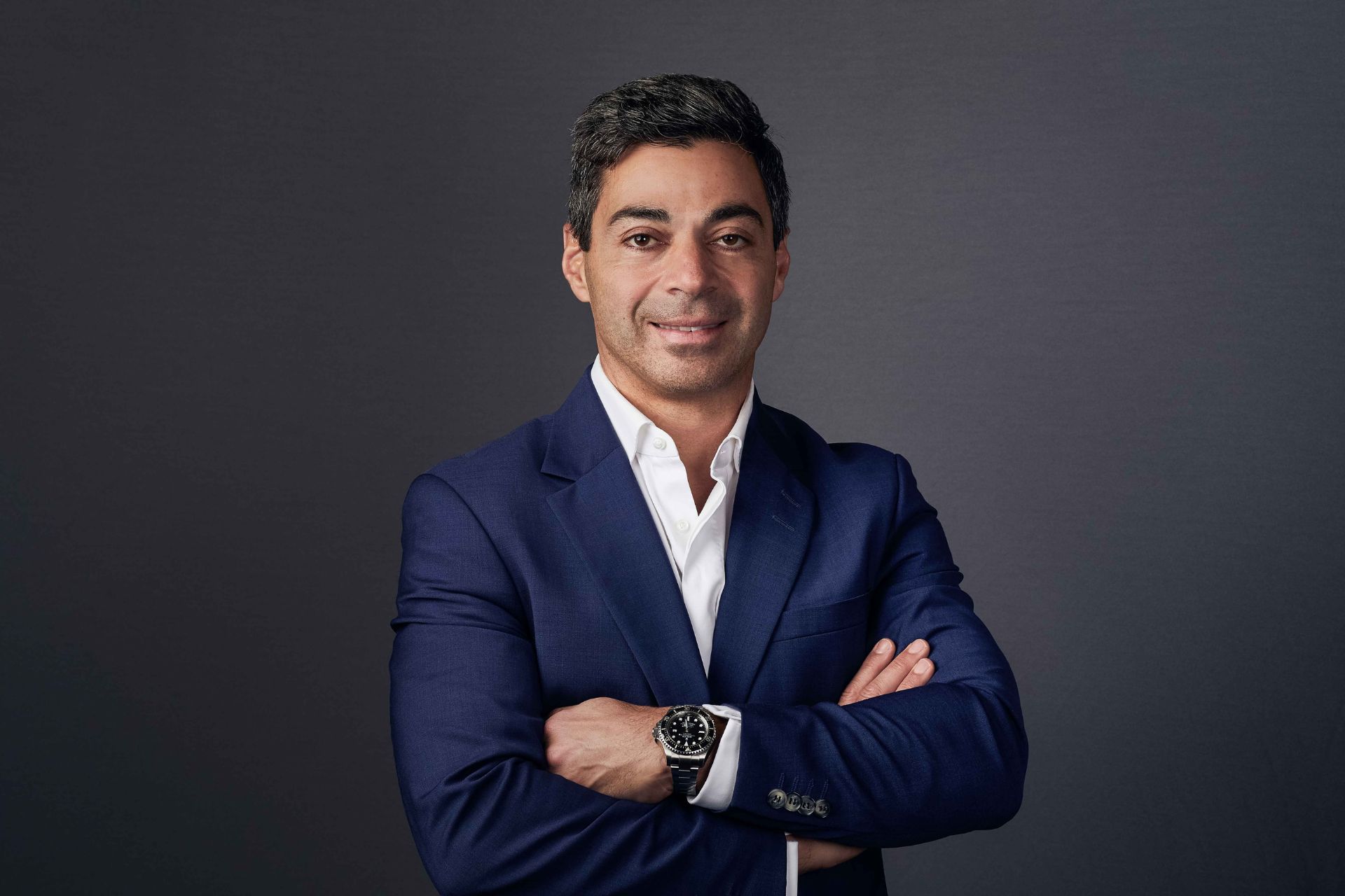 Doctor standing in front of a dark grey background
