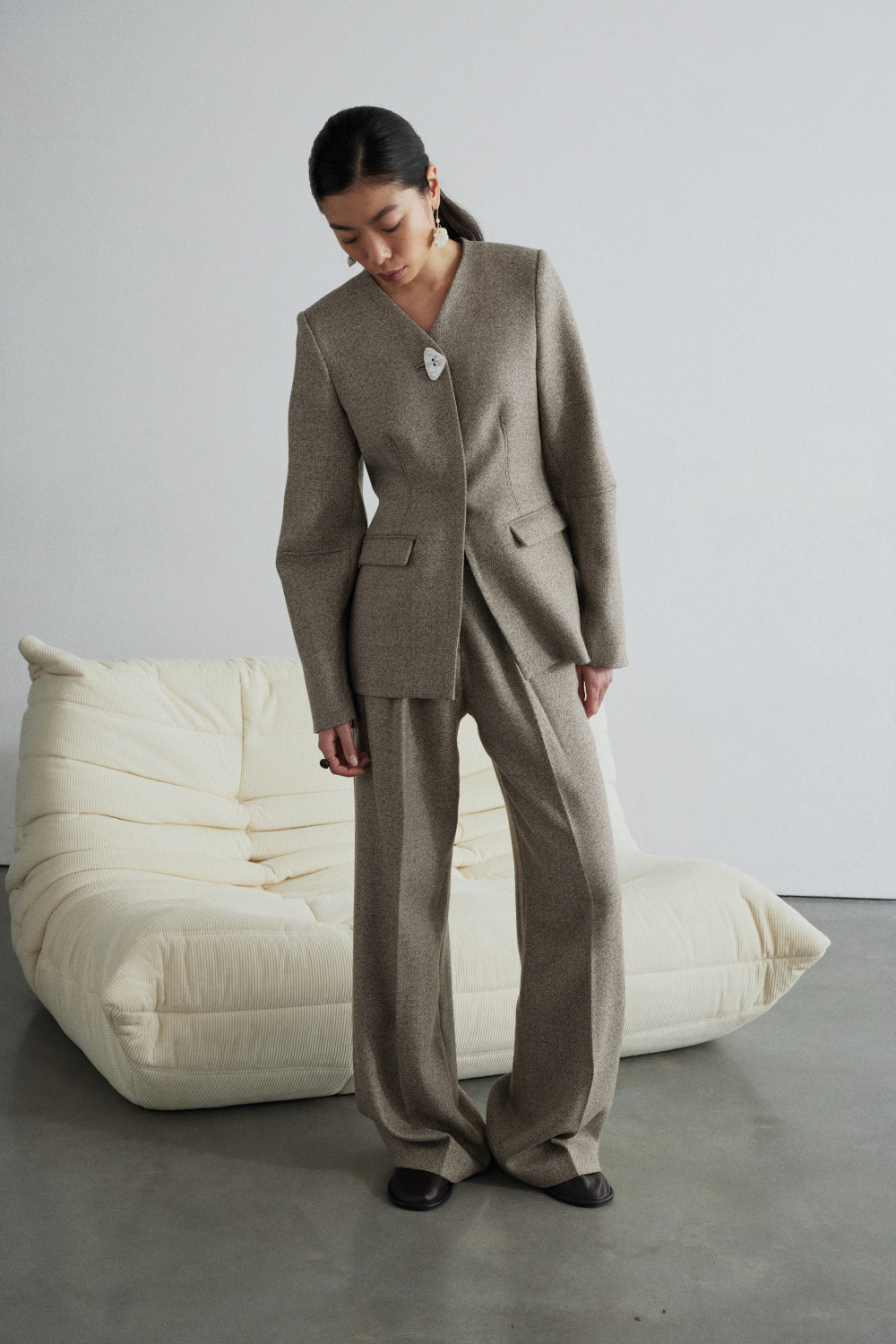 Woman in stone-coloured suit
