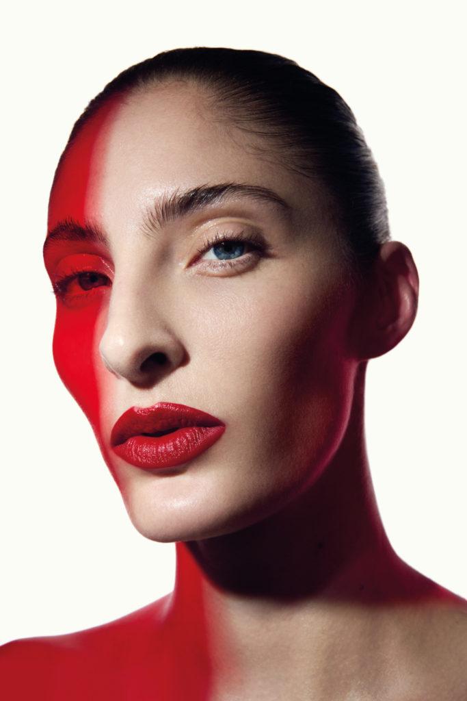 Woman with red light on face