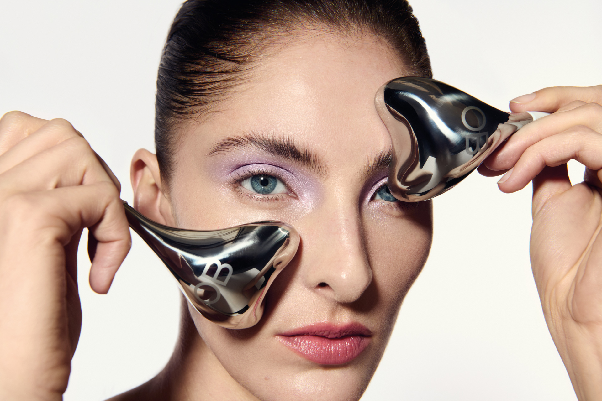 Woman holding eye globes to face | eye lift surgery
