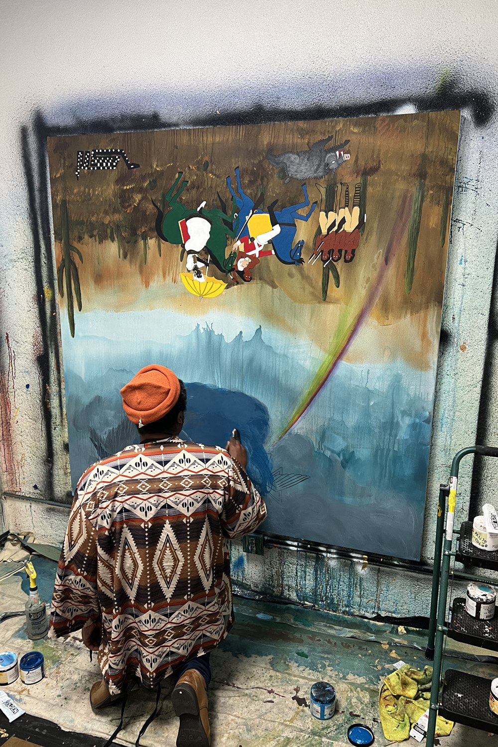 Umar Rashid painting on a canvas