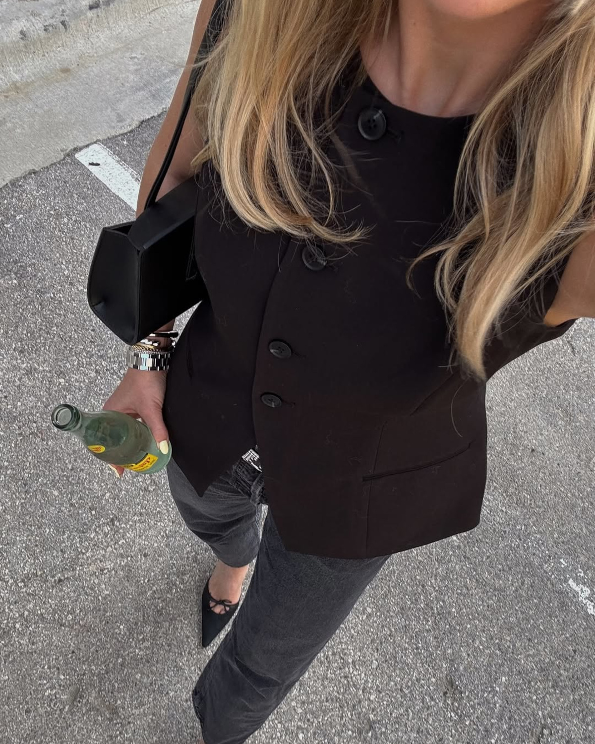 Woman in black waistcoat and jeans