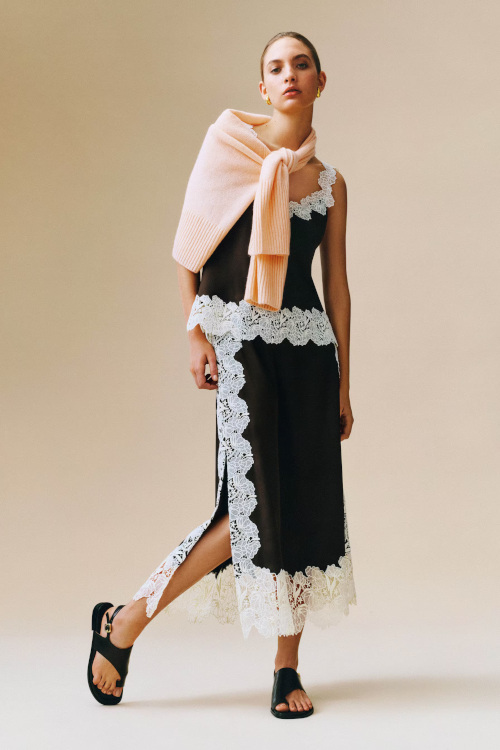 Woman in jumper, lace cami and skirt | what to wear to glastonbury