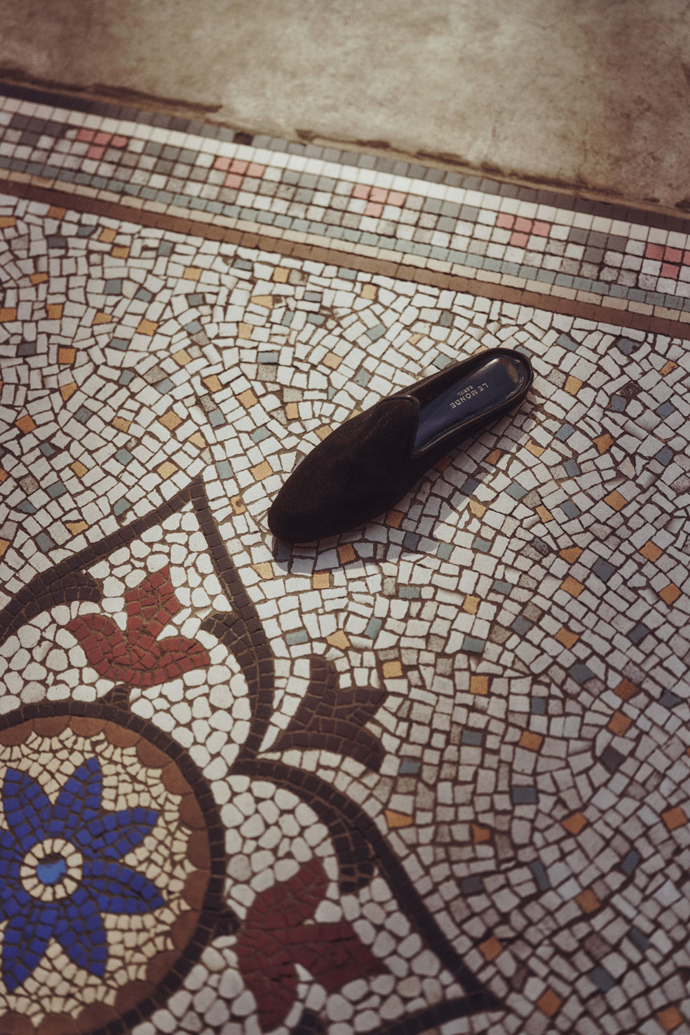A shoe on a tiled floor