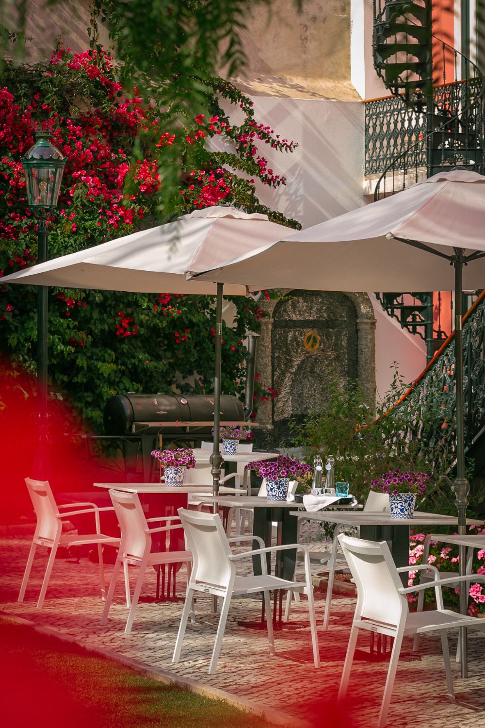 Outdoor dining area with white furniture and white umbrellas