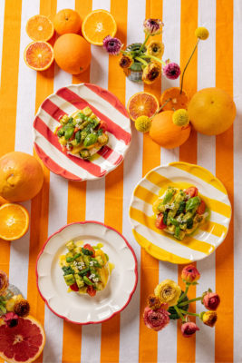 A colourful outdoor table filled with dishes