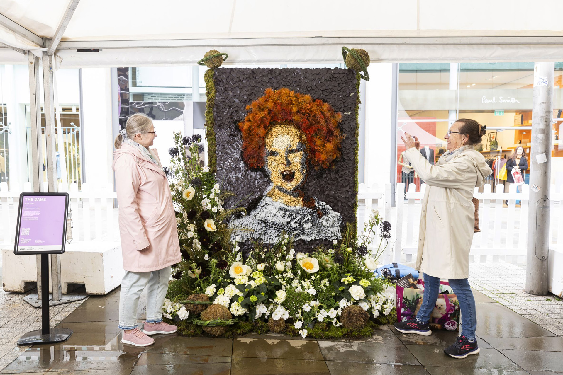 Terri Heatlie and Karen Thornton view the floral tribute to Dame Vivienne Westwood at The Manchester Flower Festival 2024