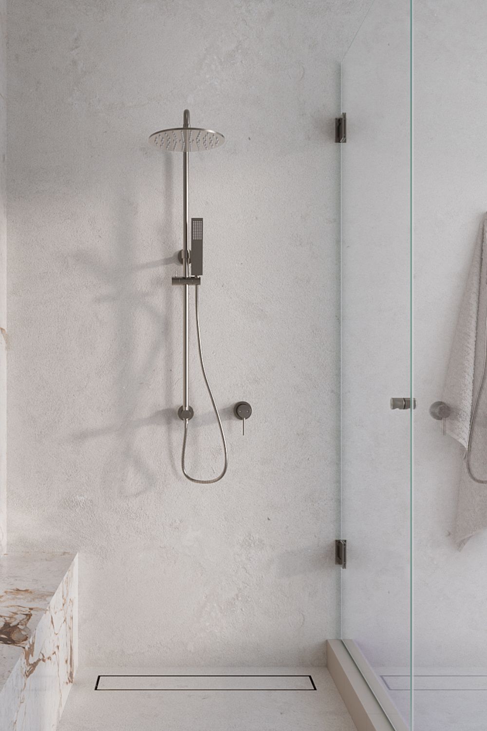 Silver shower in white marble bathroom