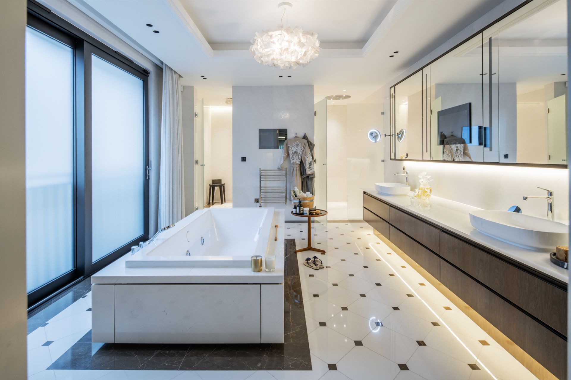 Bathroom with large rectangular standalone bathtub and a dark wooden double vanity