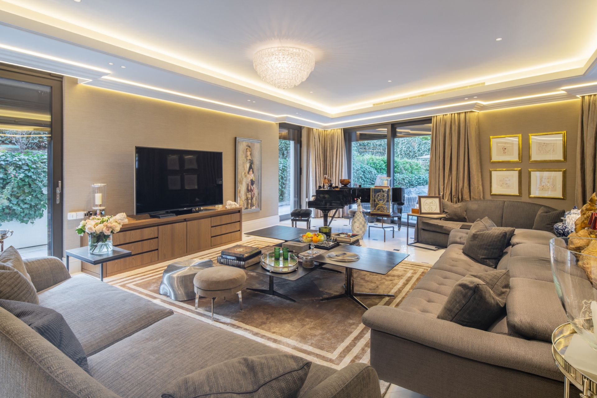 Living room with grey sofas, silk wallpaper, a grand piano and silk drapes